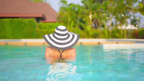 Young asian woman enjoy around outdoor swimming pool for leisure