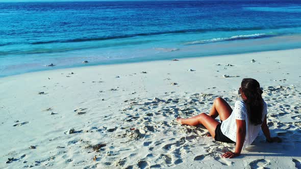 Sexy smiling ladies travelling spending quality time on beach on summer white sandy and blue 4K back