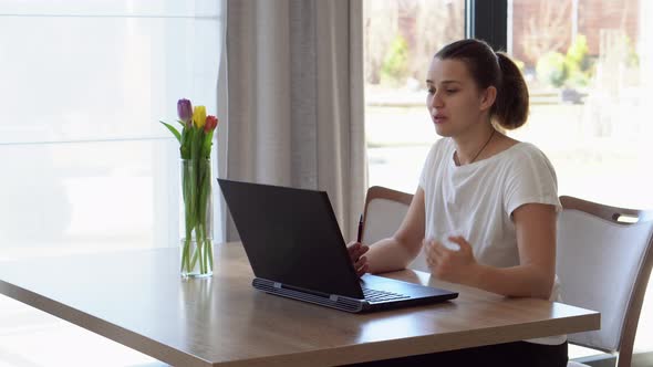 Authentic Caucasian Young Woman Chatting On Laptop At Home In Living Room