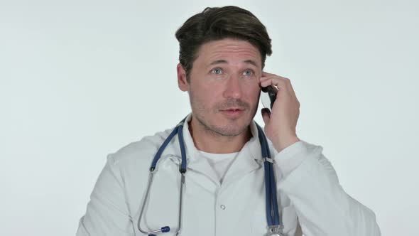 Male Doctor Talking on Smartphone , White Background