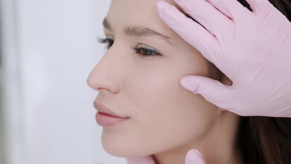 Closeup of Woman Having Facial Massage in Beauty Salon