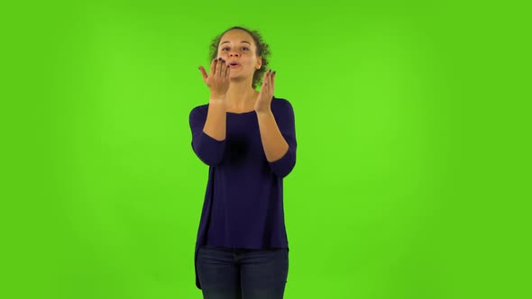 Curly Woman Smiling and Blowing Kiss. Green Screen