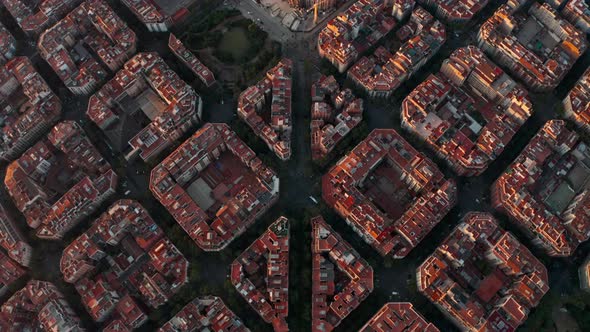 Beautiful pan up reveal drone shot of La Sagrada Familia Church Barcelona at sunrise