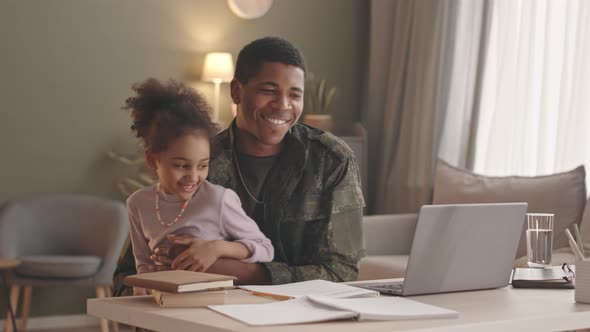 Father of Little Girl Working on Laptop from Home alt