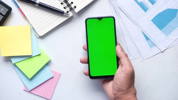 Top View of Man Hand Using Smart Phone on Office Desk