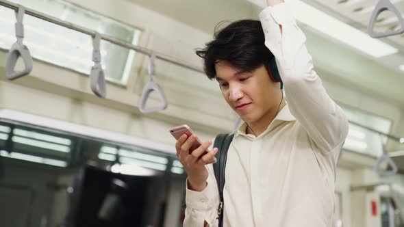 Businessman Using Mobile Phone on Public Train