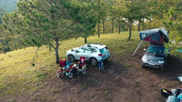 Aerial view of group Asian friends camp enjoying, relaxing nature on the hills