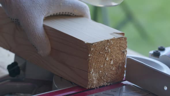 Annual Wood Rings Wood Appear While Carpenter Cuts Off Wooden Post on Mitre Saw