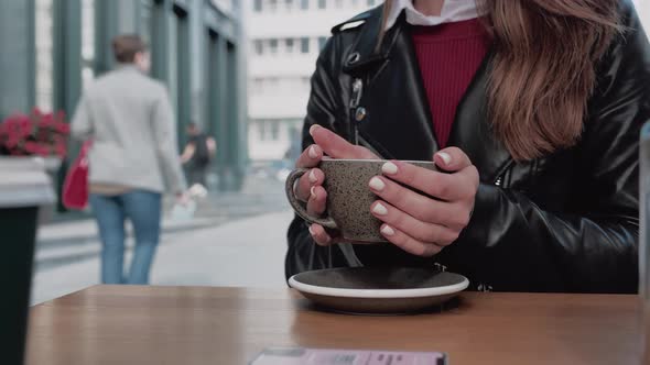 Close Up of Female Hands Drinking Hot Chocolate or Coffee and Relax in Cafe. Health Care