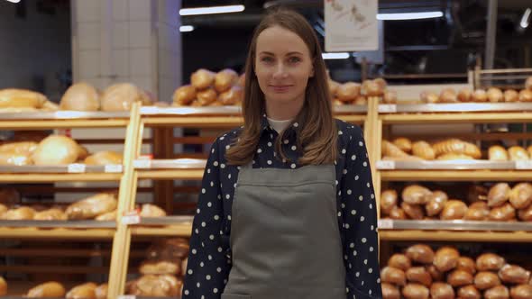 Woman Who Owns a Small Bakery in an Apron Smiles in Her Candy Store