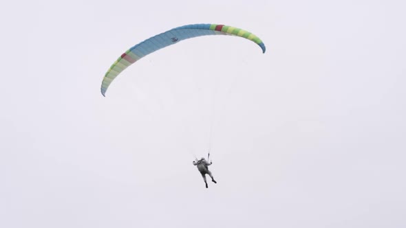 Parachutist circling in the air with a wing parachute