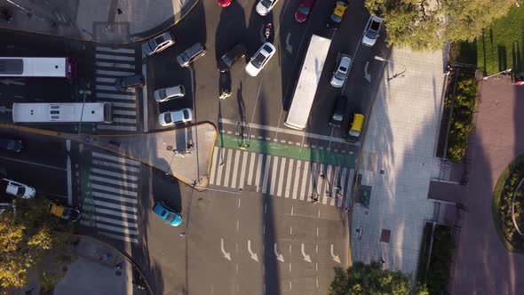 top aerial view of pedestrians passing safely on the crosswalk on a busy avenue in buenos aires city