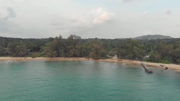 Wooden rural pier over shallow waters of Lazy Beach in Koh Rong Sanloem, Cambodia