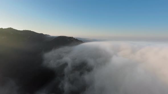 Aerial view of thick clouds over the canyon at sunrise in Malibu Canyon, Monte Nido, California, USA