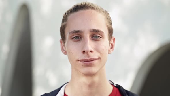 Portrait of Calm Young Blond Teenager Boy Looking Serious and Confident at Camera