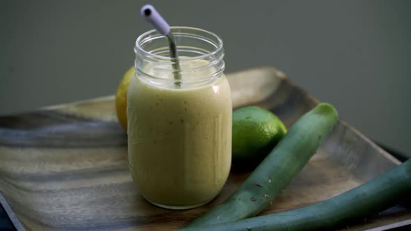 Rotating shot of Aloe Vera smoothie drink mason jar lemon lime