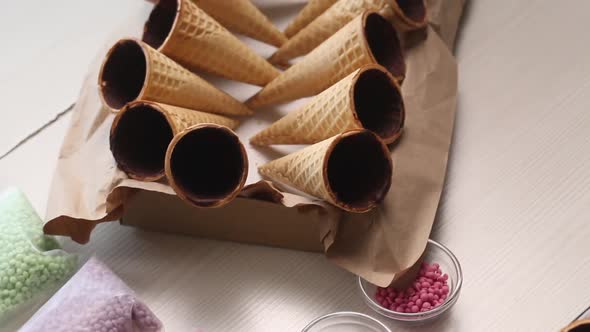 Wafer Cones Smeared Inside With Liquid Chocolate. They Are On Stands.