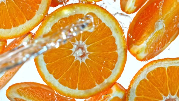 Super Slow Motion Shot of Splashing Water to Orange Slices at 1000Fps