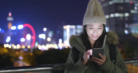 Woman use of mobile phone at night