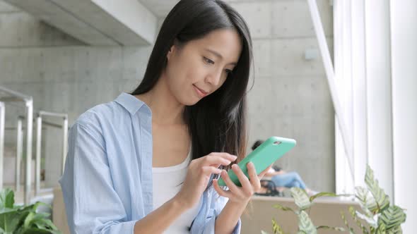 Woman Working on Mobile Phone in University