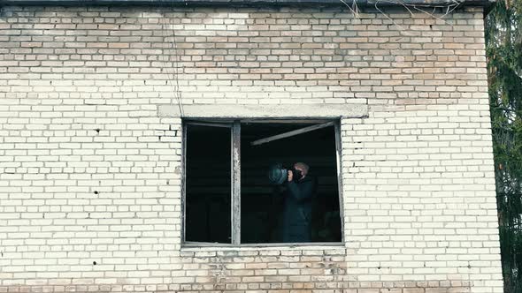 A Man with an Antitank Weapon in an Abandoned House