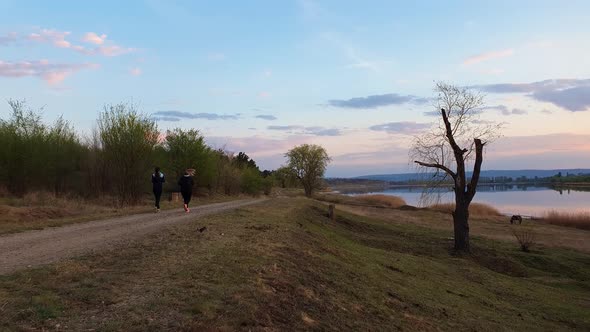 Two girl running outdoors in the park