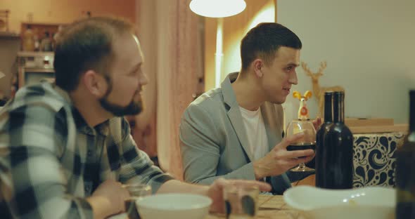 Nice Guy Drinks Wine From a Glass Laughs and Talks Among Friends