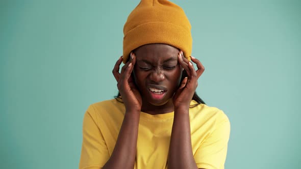 Sad African woman suffering from headache