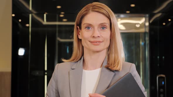 Businesswoman Smiling in Office Hall