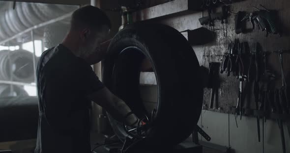 Mechanic Skiving the Tire Patch in Auto Service