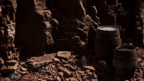 Old Wooden Vintage Wine Barrels Near Stone Wall in Canyon alt