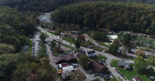 A high forwarding flyover view of the small town of Ohiopyle, Pennsylvania in early autumn. The Youg