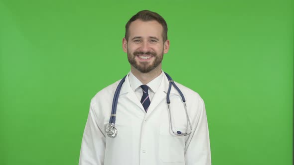 Handsome Doctor Doing Yes Sign By Head Against Chroma Key