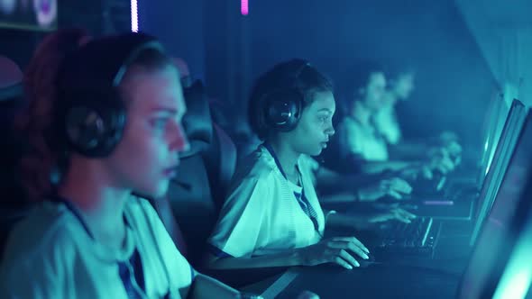 Esports Tournament Young Female Gamers in Headphones Plays a Video Game Cyber Sportsmans at the Game