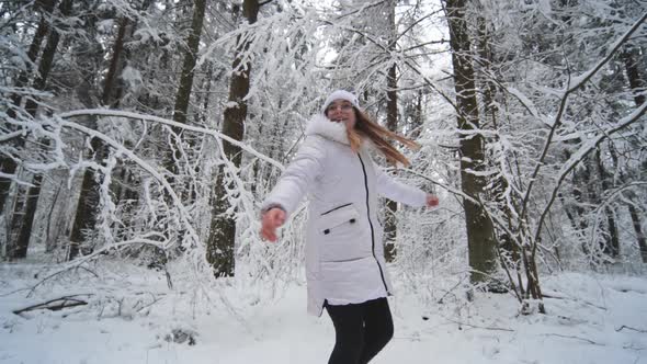 Happy Girl Spinning in a Magical Winter Forest