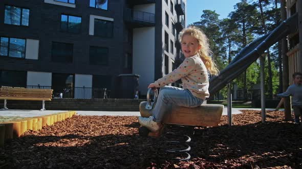 Cute Girl and Boy Playing in Park Near with Home