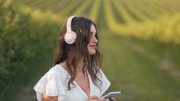 close-up portrait of a young woman listening to music on headphones and relaxing