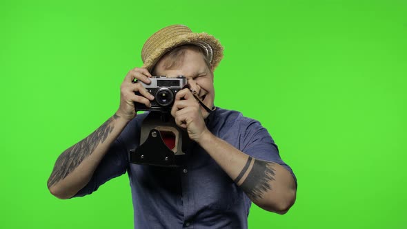 Portrait of Man Tourist Photographer Is Taking Photos on Camera. Chroma Key