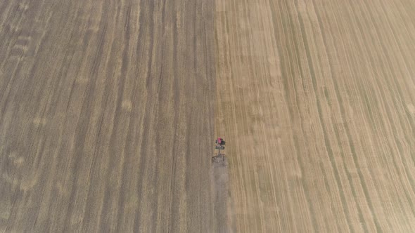 Aerial view of a tractor plowing on the fields