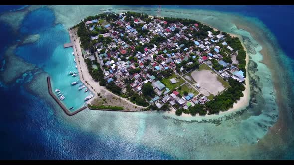 Aerial drone shot landscape of idyllic tourist beach lifestyle by aqua blue ocean with white sand ba