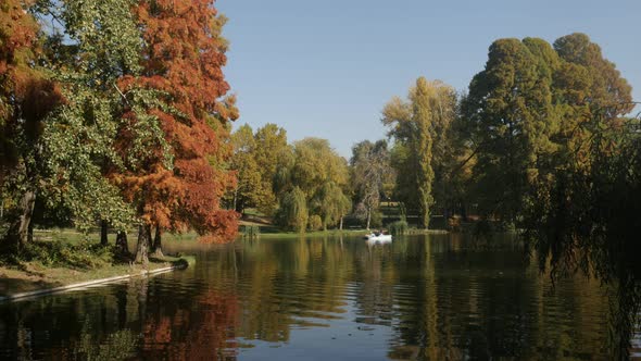 CRAIOVA, ROMANIA - OCTOBER 17, 2017 Beautiful lake  reflections in the city park with people enjoyin