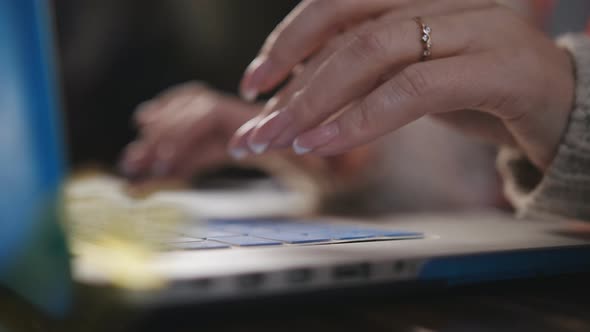 Closeup of Hands of a Woman Engineer Working for a Laptop