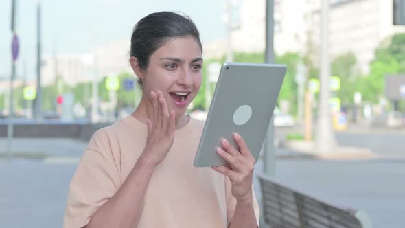Indian Woman Celebrating Online Win on Tablet
