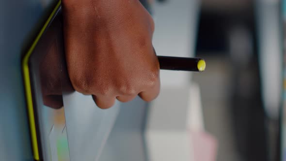 Close Up on Hand of African Photo Editor Drawing on Graphic Tablet