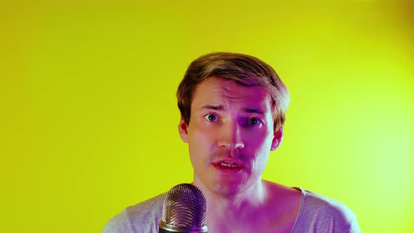 Closeup of Man Video Blogger Talking in Microphone Looking at Camera