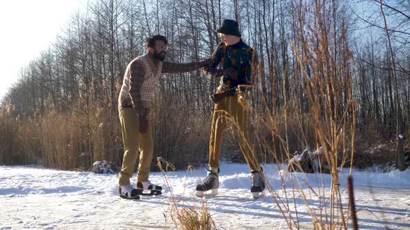 Two Indian and European Boys Learn To Skate on a Frozen Lake and Play Mischief