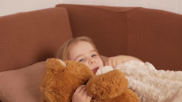 Child Plays with Toys Puts Them to Bed