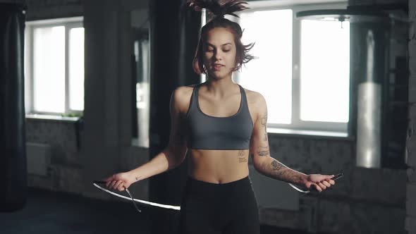 Portrait of a Girl Jumping with a Rope in the Gym