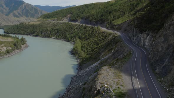 Cars on Chuya road between mountains and Katun river in Altai