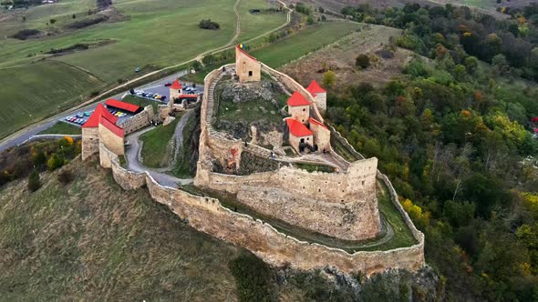 Aerial drone view of Rupea Fortress, Romania. Citadel located on a cliff, tourists